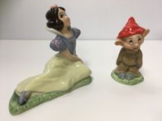 A collection of various Wade Walt Disney figures including Snow White, Dopey, Lady,