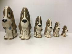 A collection of Studio Szeiler animal figures including a graduated set of five dogs and matching
