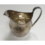 A George III silver and engraved cream jug of oval form (marks rubbed but possibly by Peter Bateman,