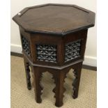 A Syrian mother of pearl and bone inlaid teak octagonal occasional table with fretwork carved