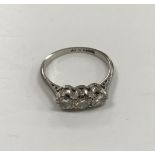 An 18-carat white gold and platinum three stone diamond ring,