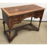 A walnut side table or dressing table in the 17th Century manner on turned cup and cover supports
