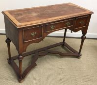 A walnut side table or dressing table in the 17th Century manner on turned cup and cover supports