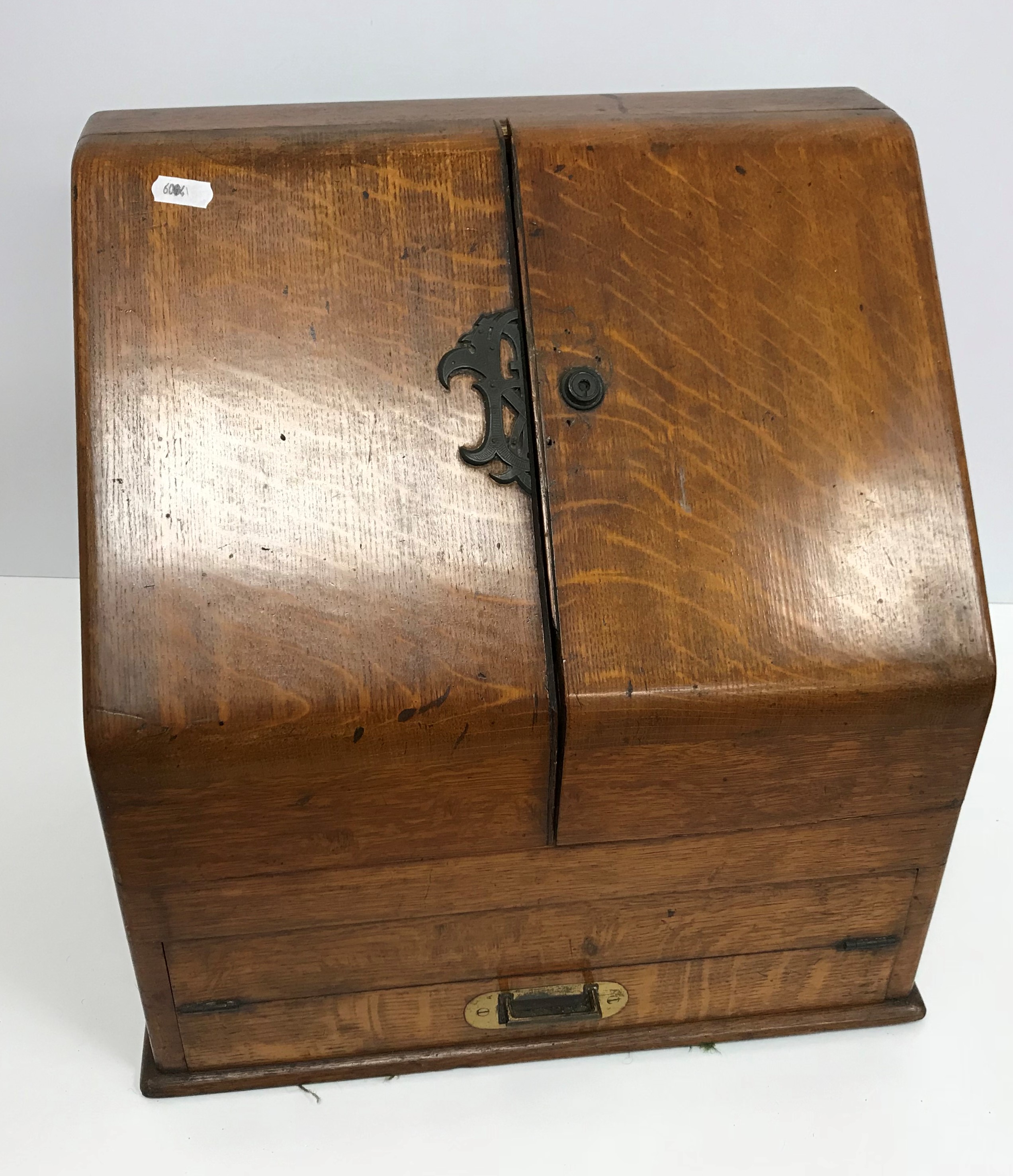 A late Victorian oak slope front stationery cabinet by Parkins & Gotto of Oxford Street,