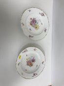 A pair of 19th Century Copenhagen porcelain floral spray and gilt decorated plates with basket work
