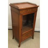 A late Victorian satinwood and marquetry inlaid Sheraton Revival music cabinet with three quarter