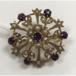 A late Victorian seed pearl and amethyst flower head brooch,