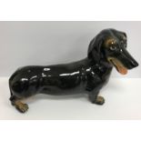 A modern Italian fireside figure of a dachshund black and tan inscribed to base "Italy S43RO"