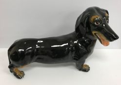 A modern Italian fireside figure of a dachshund black and tan inscribed to base "Italy S43RO"