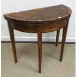 A mahogany demi lune card table in the Regency style,