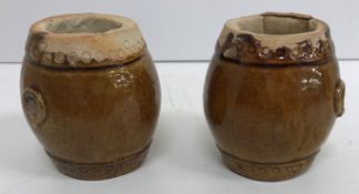 A pair of Chinese treacle glazed pottery miniature barrel shaped garden seats, 7.