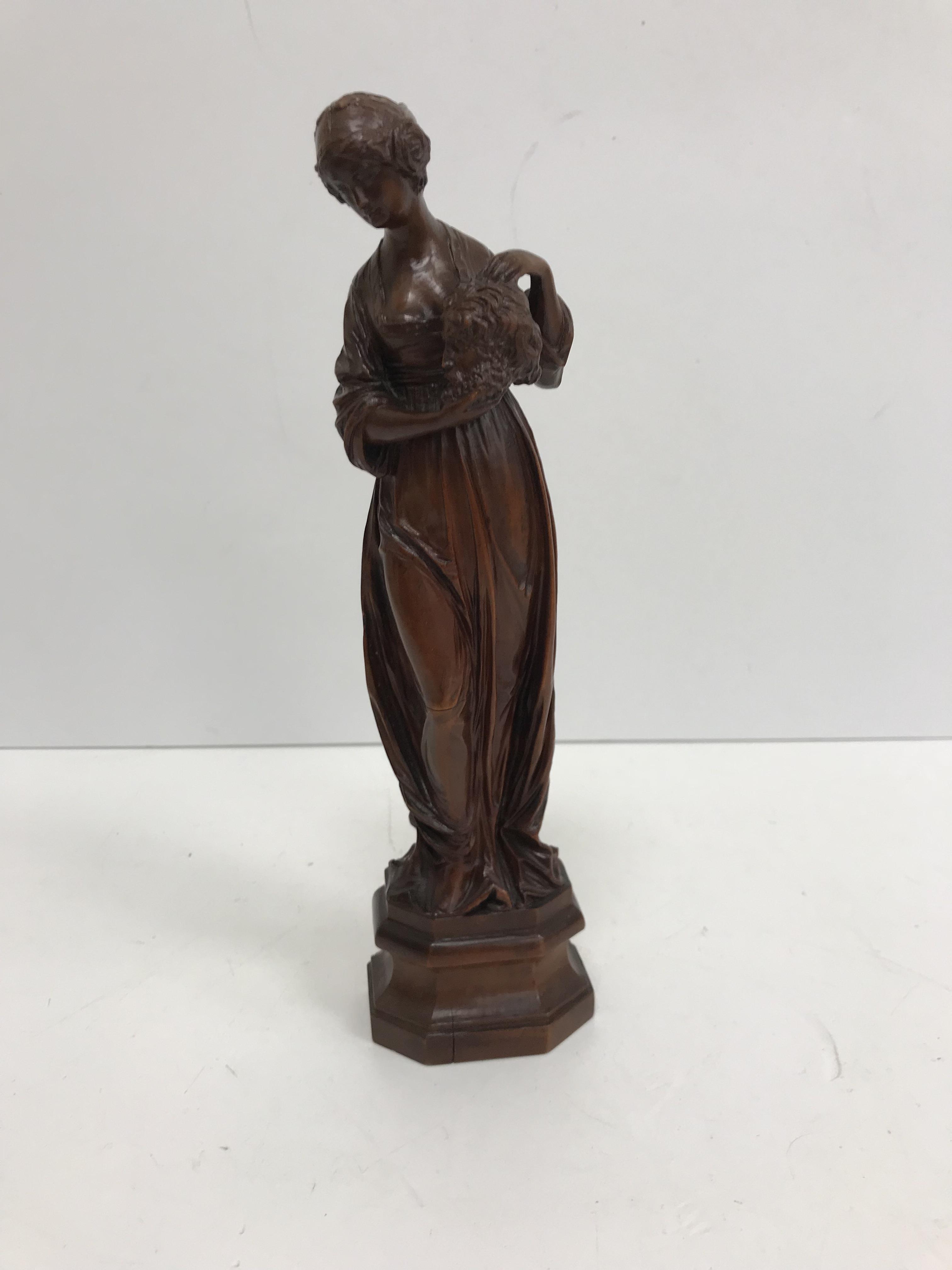 A 19th century carved boxwood figure of "Judith with the head of Holofernes",
