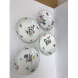 A set of four 19th Century Meissen bowls or shallow dishes with basket weave borders and gilt rims,
