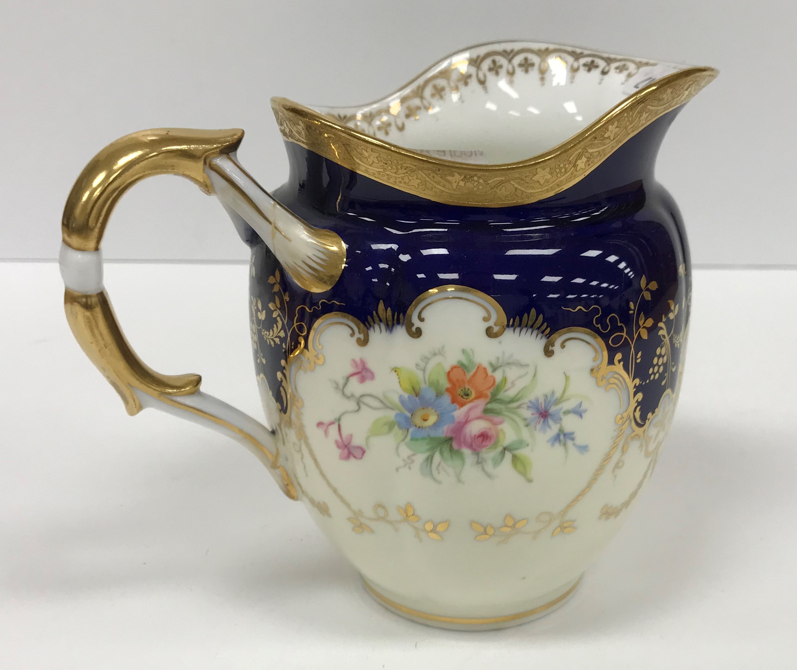 A Mintons floral spray blue and gilt decorated part tea service comprising six cups and saucers,