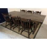 A 20th Century oak refectory style dining table, the single piece top on end trestle supports,