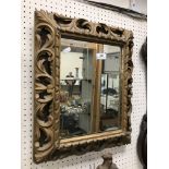 A 19th Century carved giltwood and gesso framed wall mirror in the Florentine taste with all over