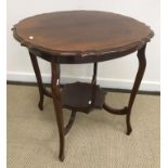 An Edwardian mahogany shaped top two tier occasional table,