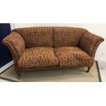 A circa 1900 upholstered scroll arm sofa by Howard & Sons of Berner Street,