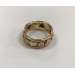 A 14-carat gold grape and vine decorated ring,