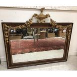 A circa 1900 mahogany and gilt framed wall mirror in the early Georgian style with ram's head