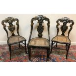 A pair of Victorian black lacquered mother of pearl inlaid and gilded salon chairs,