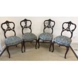 A set of four Edwardian mahogany and carved salon chairs in the Rococo taste with upholstered seats