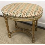 A circa 1900 carved giltwood and gesso framed oval dressing stool with upholstered seat raised on