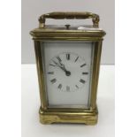 A circa 1900 French lacquered brass cased carriage clock, the white enamel dial with Roman numerals,