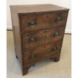 An early 19th Century oak chest of three long graduated drawers on bracket feet 63 cm wide x 85.