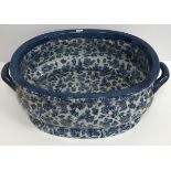 A modern blue transfer floral decorated oval foot bath in the 19th Century manner 56 cm x 37 cm