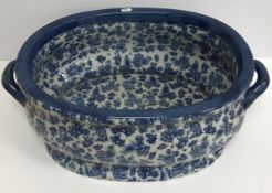 A modern blue transfer floral decorated oval foot bath in the 19th Century manner 56 cm x 37 cm