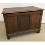 An early 20th Century oak coffer or blanket chest, the palin top abouve three plain panels,