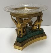 A 19th Century French gilt metal stand with associated pineapple cut glass dish on a foliate