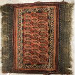 A vintage Afshar tribal rug, the central panel set with repeating hook motifs on a red ground,