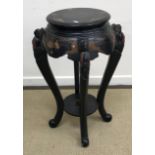 A 20th Century black lacquered and chinoiserie decorated urn stand on cabriole legs united by an