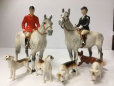 A Beswick hunting set comprising lady rider on horseback, gentleman on horseback,