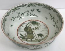 A 19th Century Chinese famille verte fruit bowl decorated with figure and Kylin/Qilin amongst