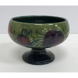 A Moorcroft green ground pansy decorated pedestal bowl raised on a circular foot 15 cm diameter x