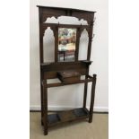 An early 20th Century oak hall stand with coat hooks and glove box flanked by stick stands 84 cm