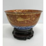 A Chinese oxide red and gilt banded blue and white deep bowl,