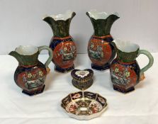 A pair of Masons ironstone Japan pattern vases with gilt on green decorated flared rims over a