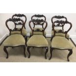 A set of six William IV rosewood and carved kidney backed dining chairs with upholstered seats on