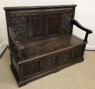 A carved oak settle in the 17th Century manner,