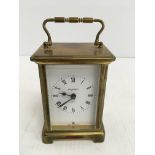 A brass cased carriage clock, the dial with Roman numerals inscribed "Bayard 8 day", 11.