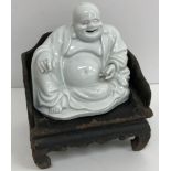 An 19th Century Chinese blanc de chine figure of a smiling Buddha with open mouth and hollow base,