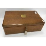 An oak cutlery canteen containing various plated cutlery with brass cartouche inscribed "Presented