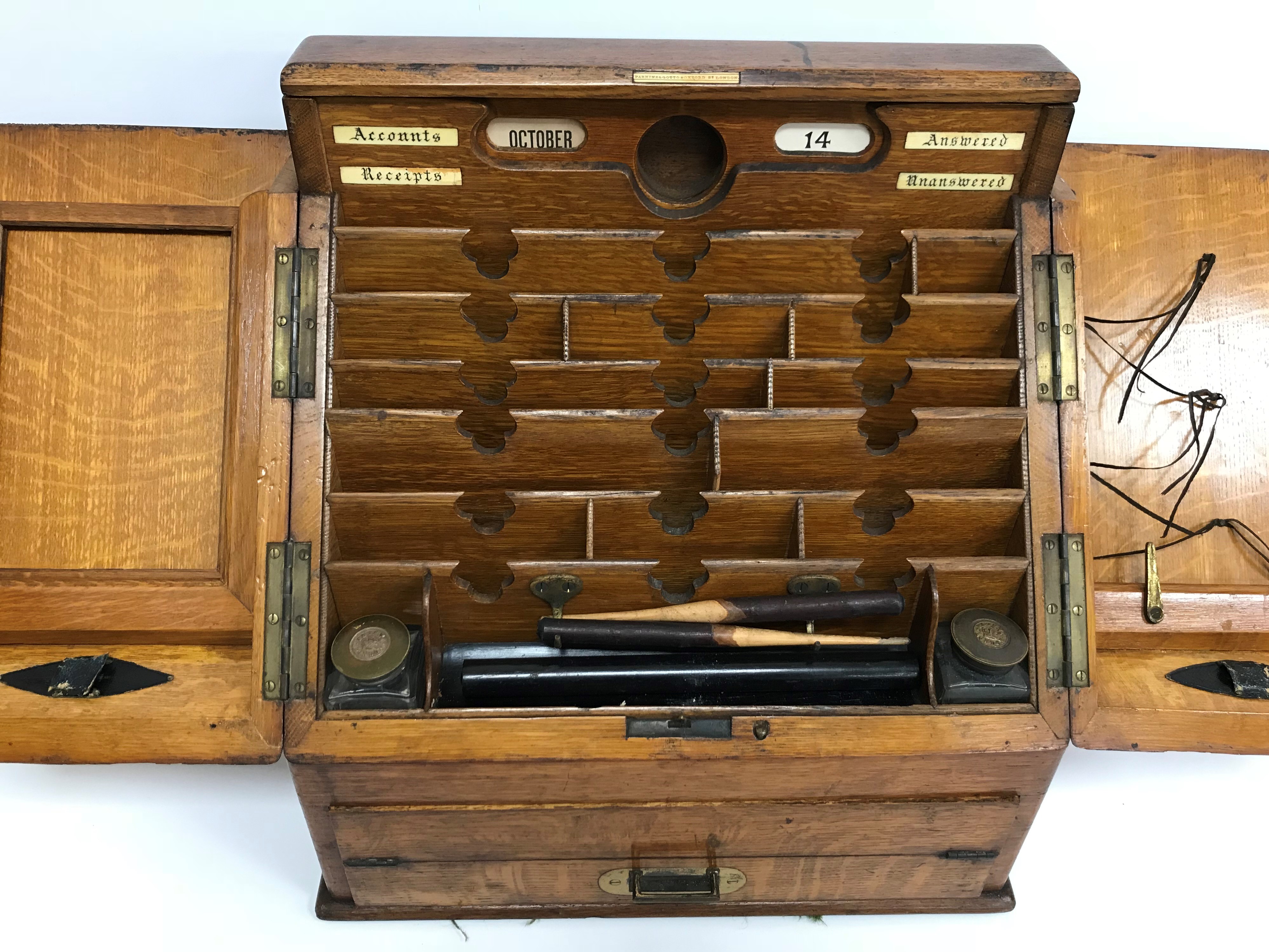 A late Victorian oak slope front stationery cabinet by Parkins & Gotto of Oxford Street, - Image 2 of 3