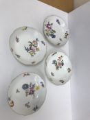 A set of four 19th Century Meissen bowls or shallow dishes with basket weave borders and gilt rims,