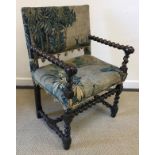 A 17th Century Dutch walnut framed barley twist decorated armchair with verdure tapestry back panel