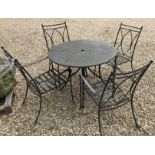 A modern painted metal garden table with granite top and four chairs with scroll arms